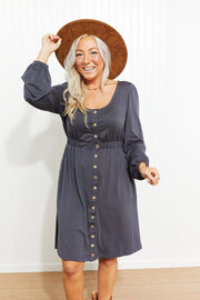 Button-down empire waist mini dress in gray with long sleeves and a scoop neckline.