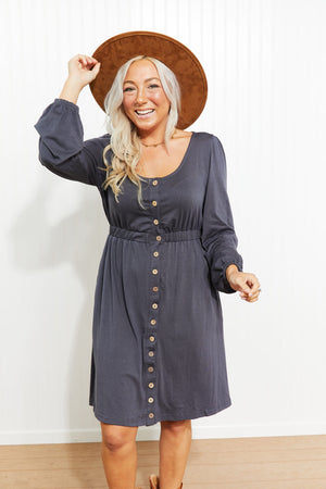 Button-down empire waist mini dress in gray with long sleeves and a scoop neckline.