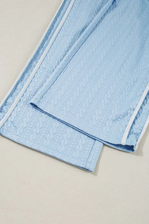 Light blue cable knit loungewear pants with white contrast trim detail.