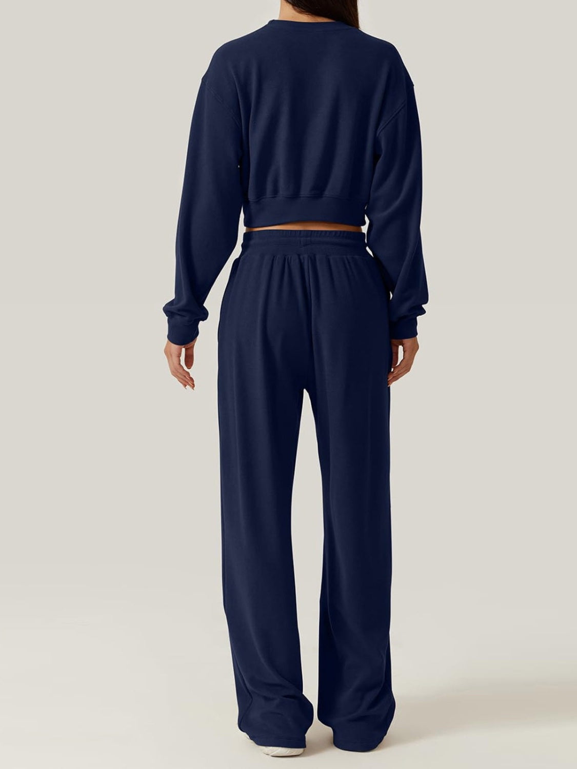 Navy knit loungewear set with cropped sweatshirt and wide-leg pants.