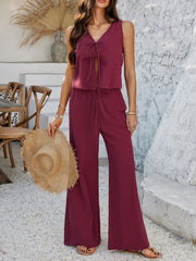 Burgundy linen tie-front palazzo pant set with drawstring waist and sleeveless V-neck top.
