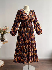 Floral V-neck maxi dress with long sleeves, tiered skirt, and lace trim.