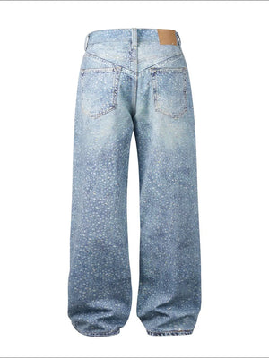 Embellished wide-leg denim trousers in medium wash with all-over sparkle details.