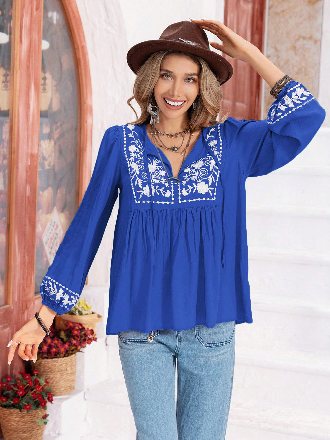 Royal blue embroidered yoke blouse with gathered bodice and tie neck.