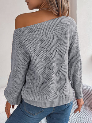Off-the-shoulder charcoal knit sweater with openwork detail and long sleeves.