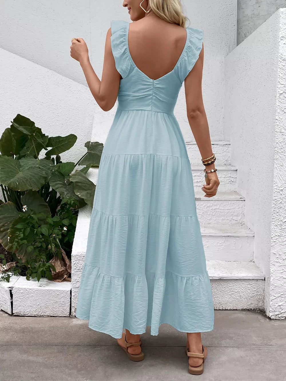 Light blue tiered maxi dress with flutter sleeves and V-neck, shown from the back.