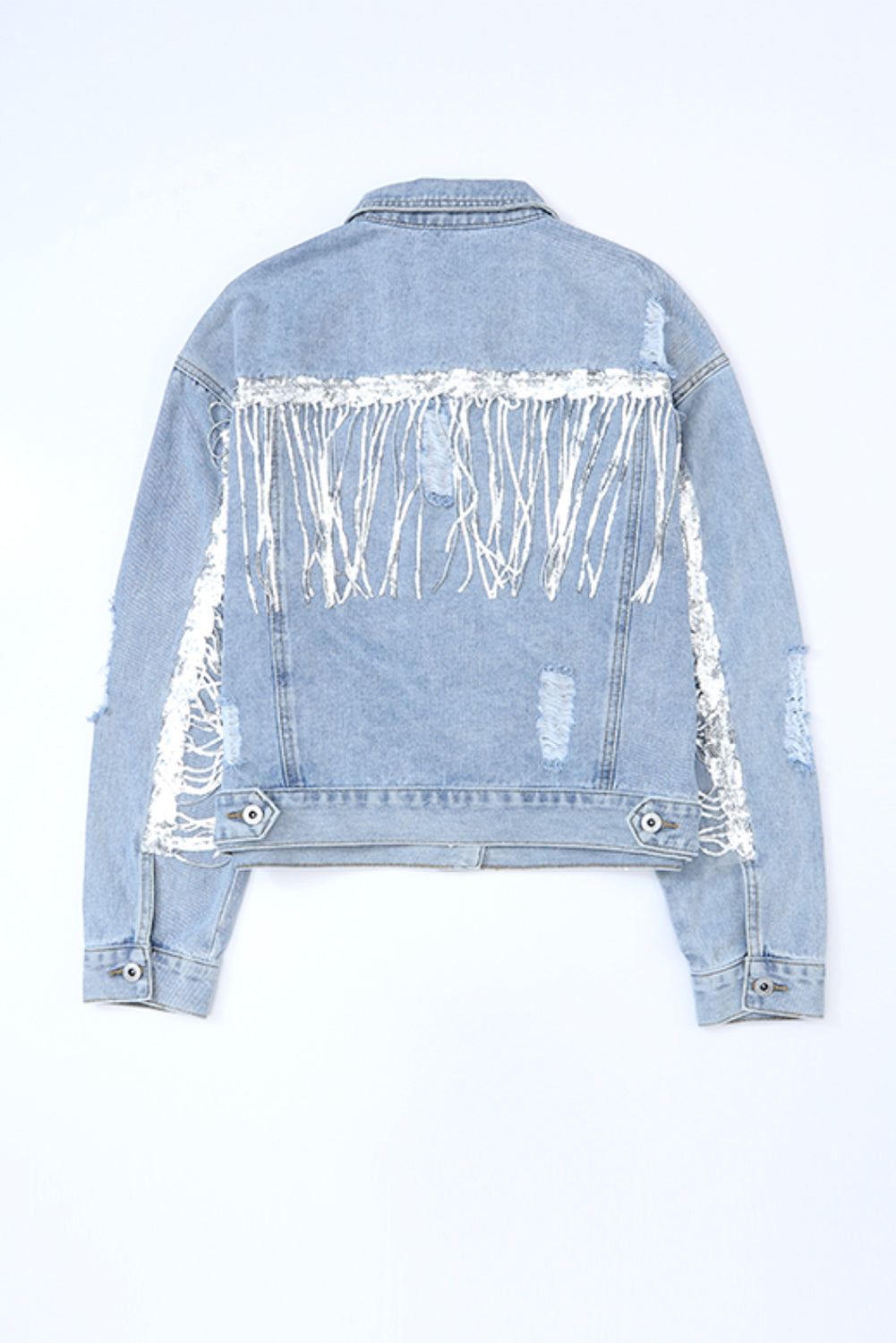 Denim trucker jacket with sequin fringe and distressed details.