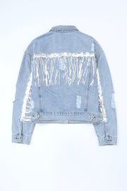 Denim trucker jacket with sequin fringe and distressed details.