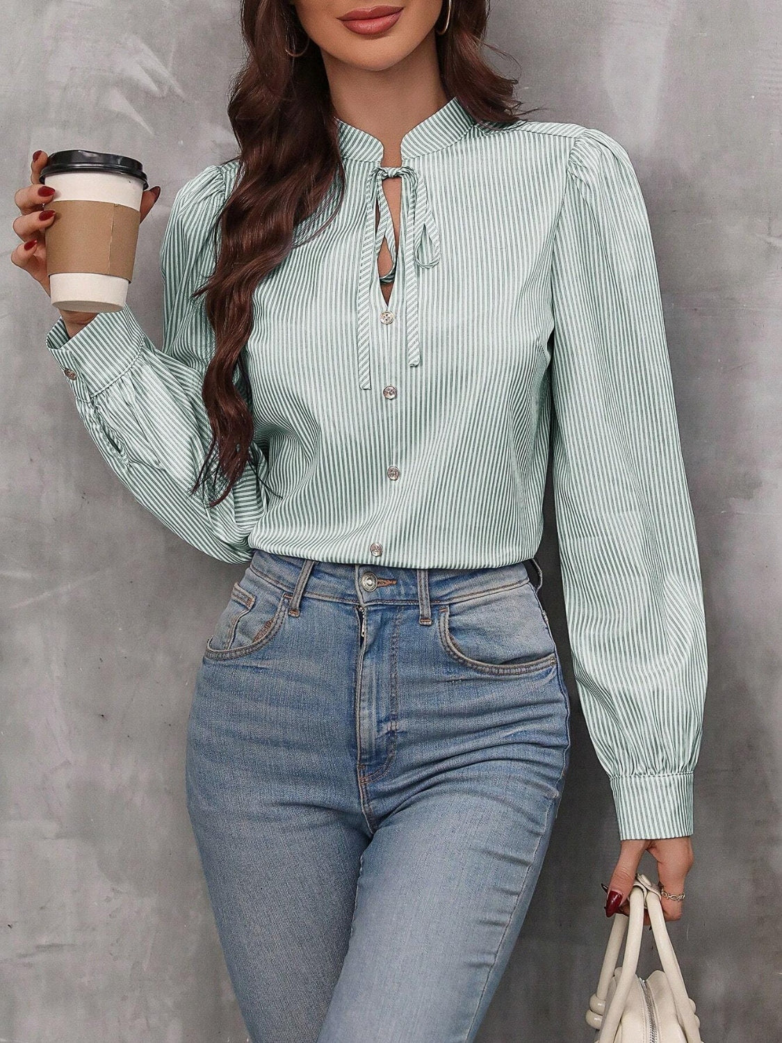 Green striped blouse with puff sleeves and neck tie detail.