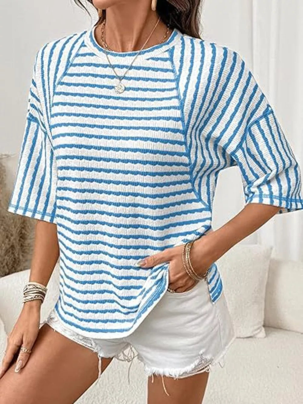 Light blue and white wavy stripe knit t-shirt with relaxed fit and crew neck.