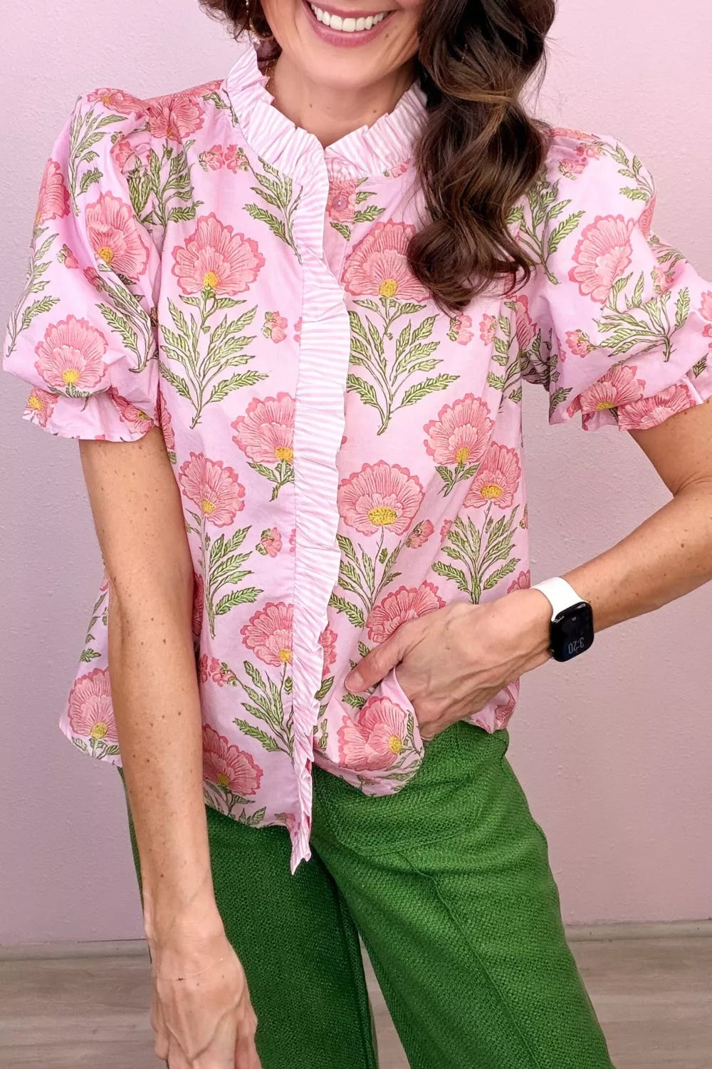 Blush pink floral puff sleeve maternity blouse with ruffled placket and striped trim.