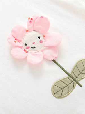 Toddler cotton set with a pink floral applique featuring a smiling face and embroidered leaves.