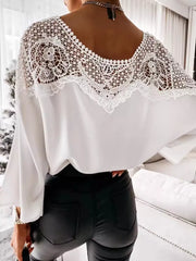 White long sleeve shirt with intricate lace yoke and bell sleeves.