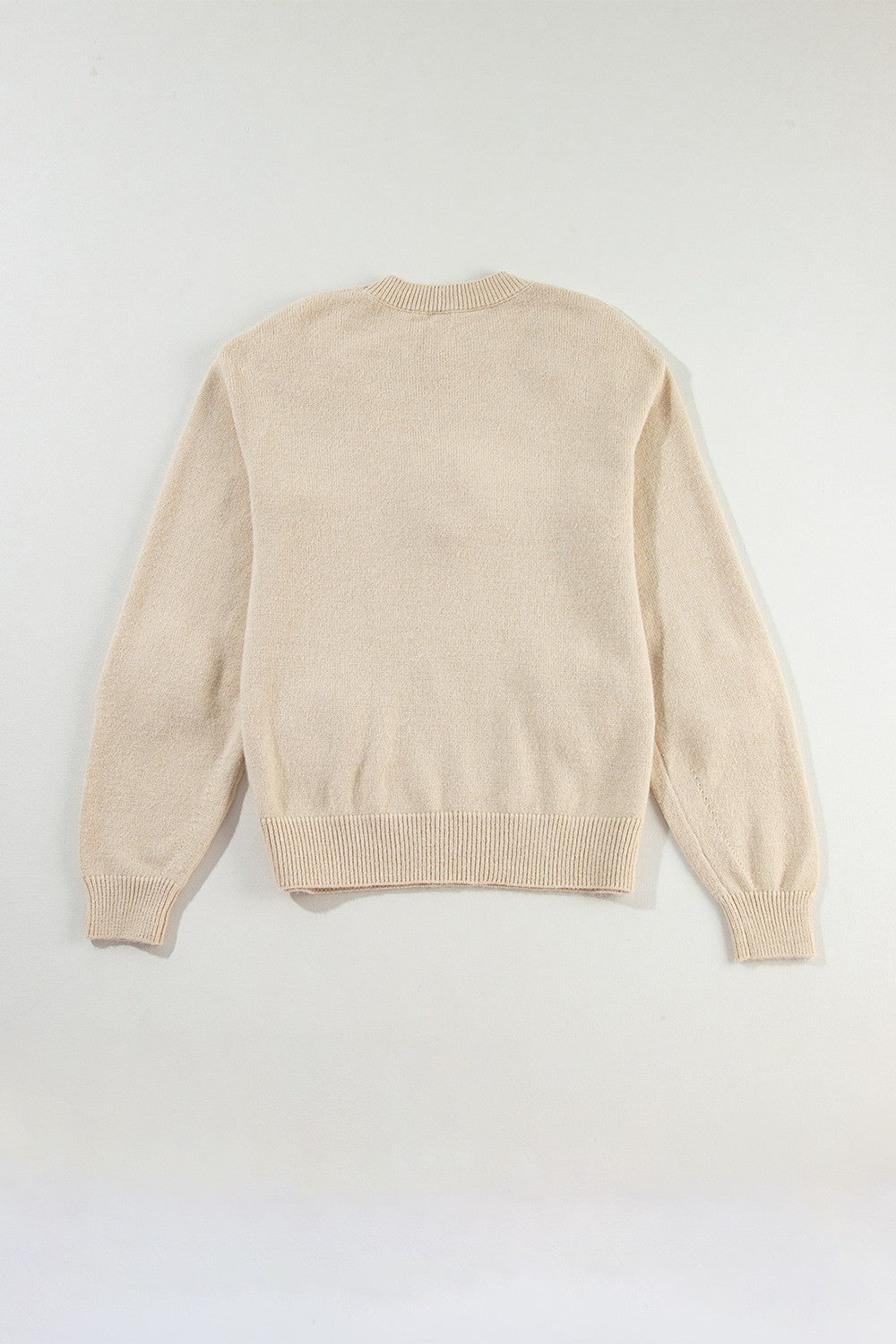 Tan knit sweater with crew neck and ribbed cuffs and hem.