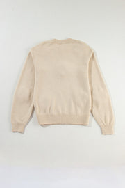 Tan knit sweater with crew neck and ribbed cuffs and hem.