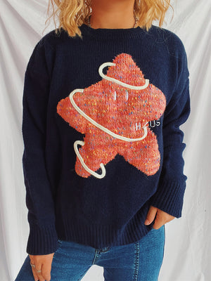 Navy knit jumper with embroidered starburst detail and white piping, crewneck, long sleeves.