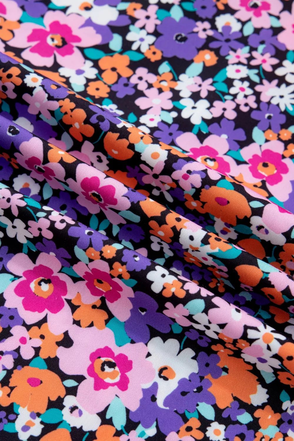 Floral drape v-neck shirt with plaid trim in polyester, featuring a vibrant floral print.