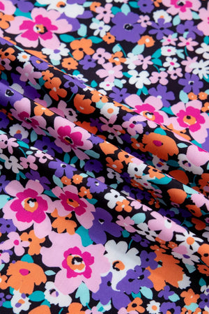 Floral drape v-neck shirt with plaid trim in polyester, featuring a vibrant floral print.