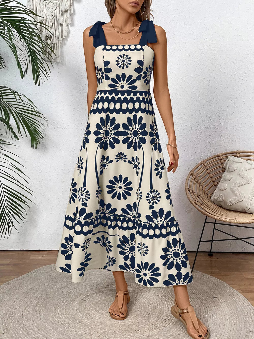 Charming floral tie-shoulder midi dress in cream with dark blue floral print and a-line cut.