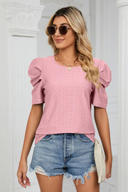 Pink perforated sleeve blouse with puff sleeves and crew neck.