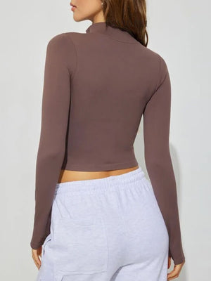 Chocolate high-neck cropped active top with long sleeves.