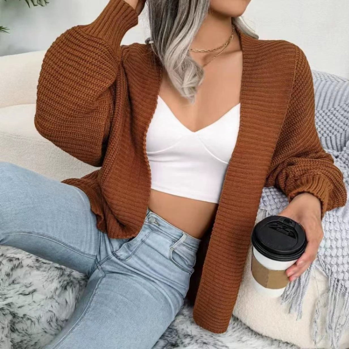 Brown chunky knit dolman sleeve cardigan with ribbed texture and open front.