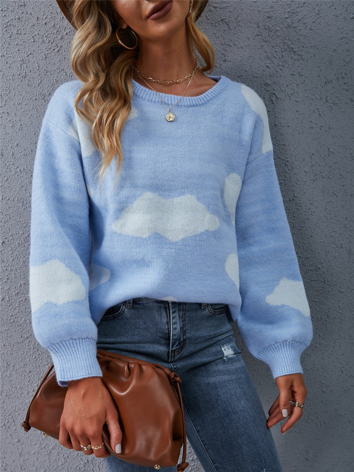 Light blue acrylic intarsia knit sweater with a cloud pattern, crew neck, and balloon sleeves.