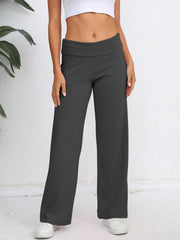 Dark gray palazzo trousers with fold-over waistband, wide leg, and a relaxed fit.