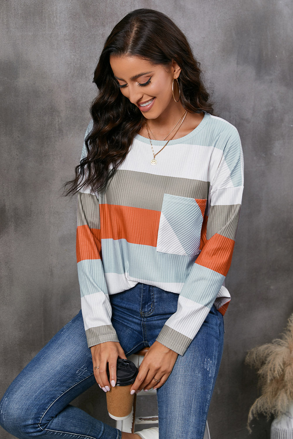 Ribbed stripe long sleeve top with patch pocket in multi-color stripes.