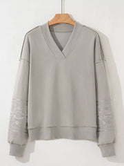 Gray V-neck sweatshirt with Aztec embroidered sleeves and comfortable fit