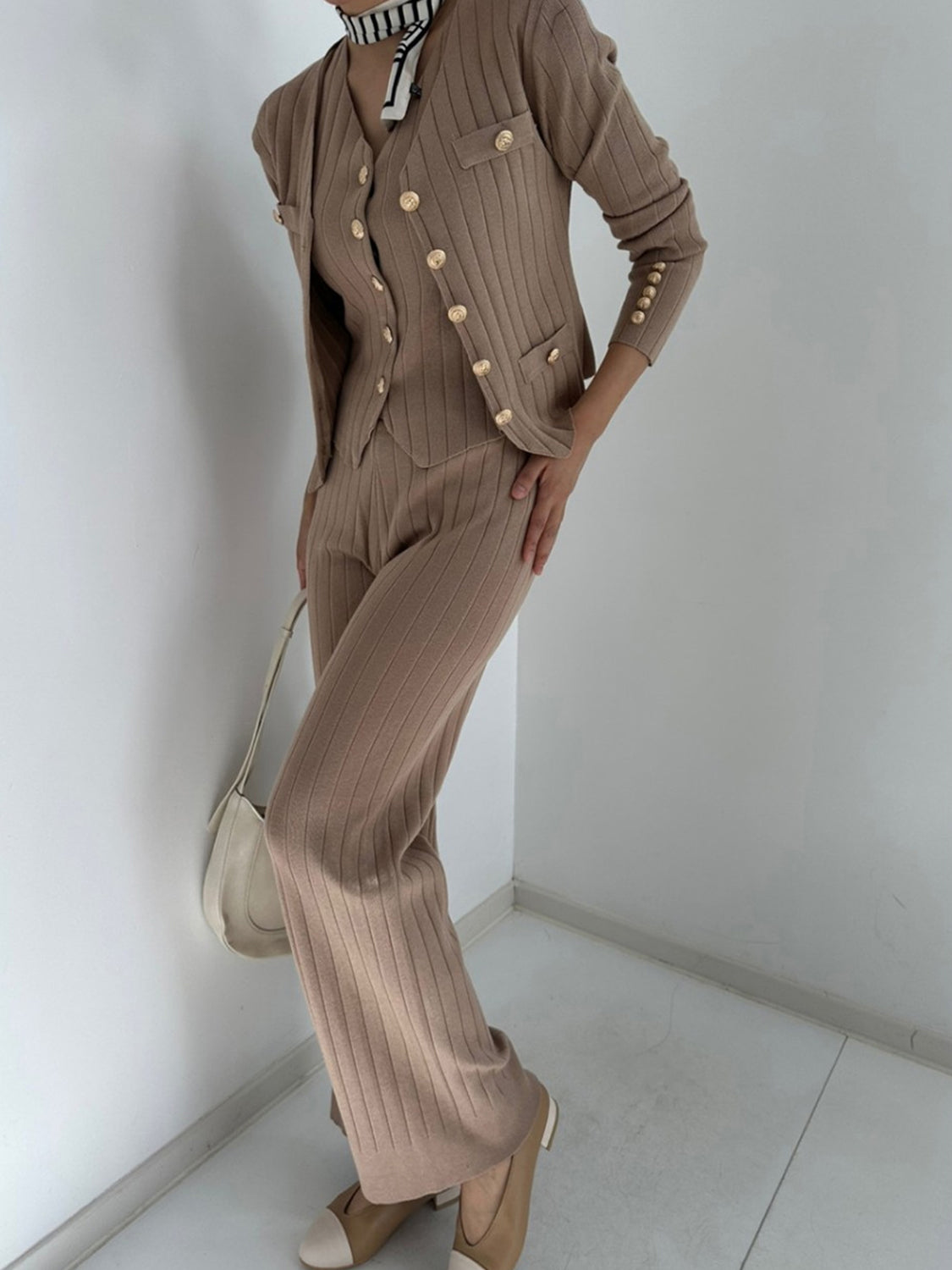 Taupe ribbed knit ensemble with gold buttons, featuring a cardigan and pants.