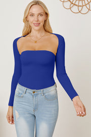 Royal blue long sleeve bodysuit with square neckline and open back detail, styled with jeans.