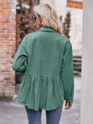 Turquoise corduroy peplum shirt jacket with buttoned cuffs and a ruffled hem.