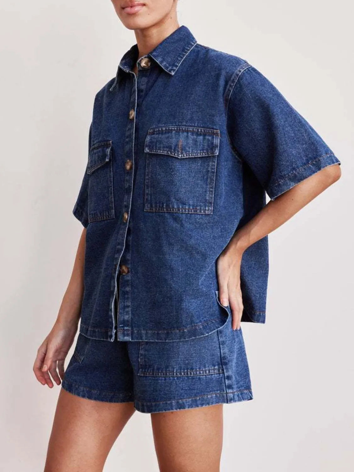 Medium wash denim co-ord set with short sleeve button-up shirt and shorts.