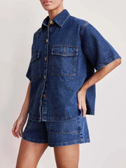 Medium wash denim co-ord set with short sleeve button-up shirt and shorts.