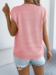 Blush pink cable knit sweater vest with cap sleeves and a crew neck.