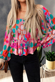 Multicolor floral smocked blouse with square neckline and ruffled hem.