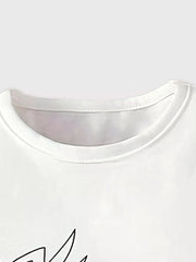 White cotton tee with playful giraffe graphic and floral accents.