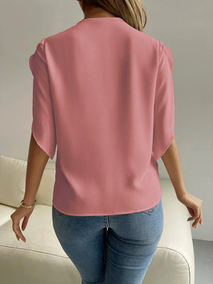 Dusty pink polyester blouse with cape sleeves and lace trim detail.