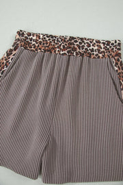 Brown ribbed knit shorts with elastic leopard print waistband and side trim.