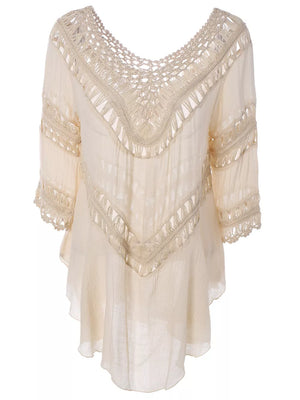 Apricot flowy cover-up with crochet trim and fringe details.