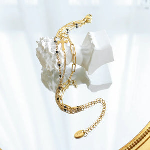 Gold layered chain and bead bracelet trio with cross charm