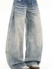 Men's light blue washed wide leg cotton jeans with distressed details.