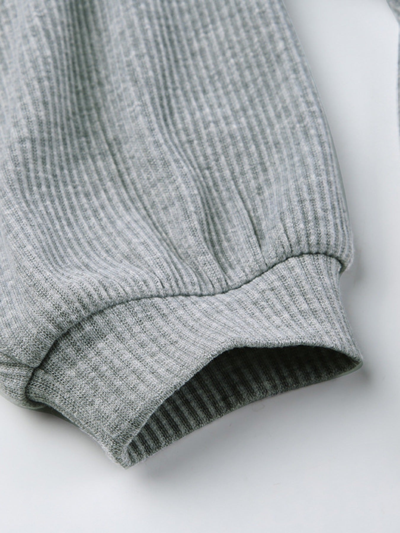 Grey ribbed knit hoodie sleeve cuff detail
