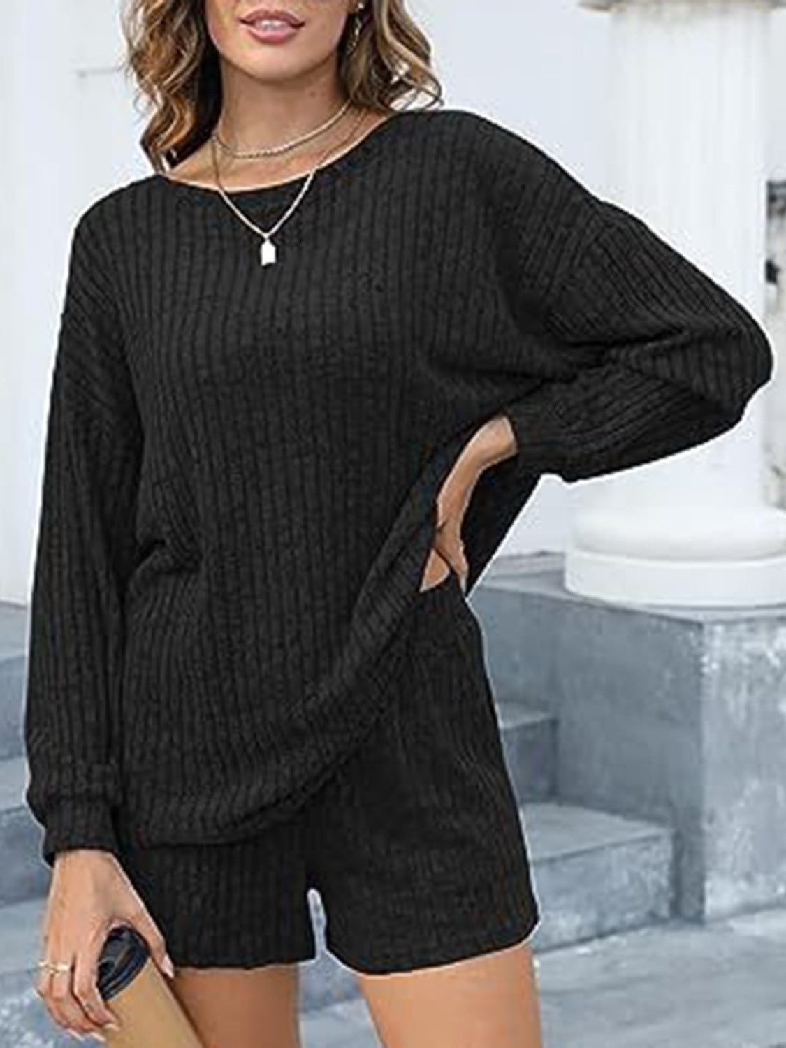 Black ribbed knit loungewear set with long sleeves and shorts, featuring side pockets.