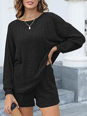 Black ribbed knit loungewear set with long sleeves and shorts, featuring side pockets.