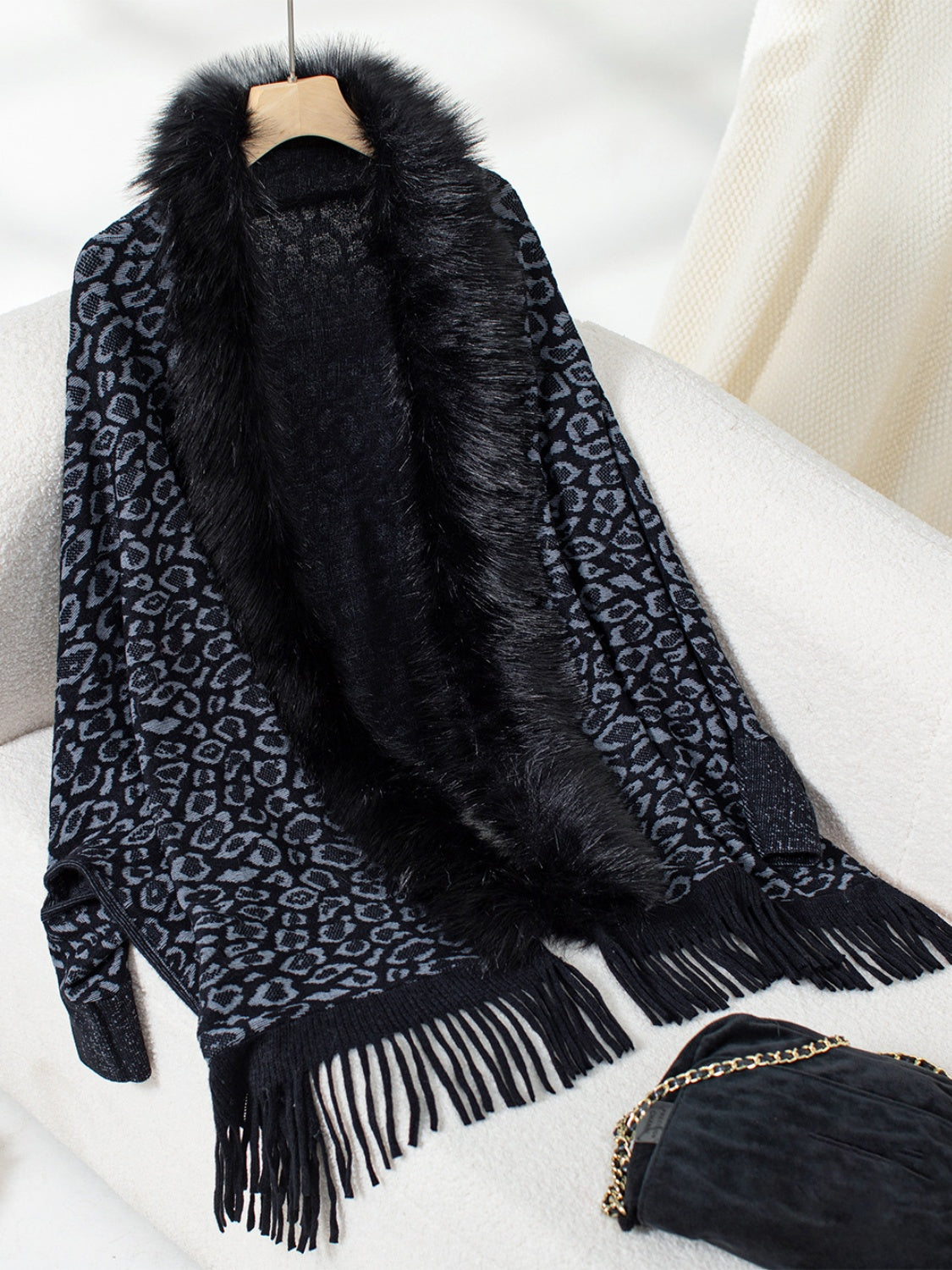 Black leopard print acrylic cardigan with faux fur trim and fringe detail