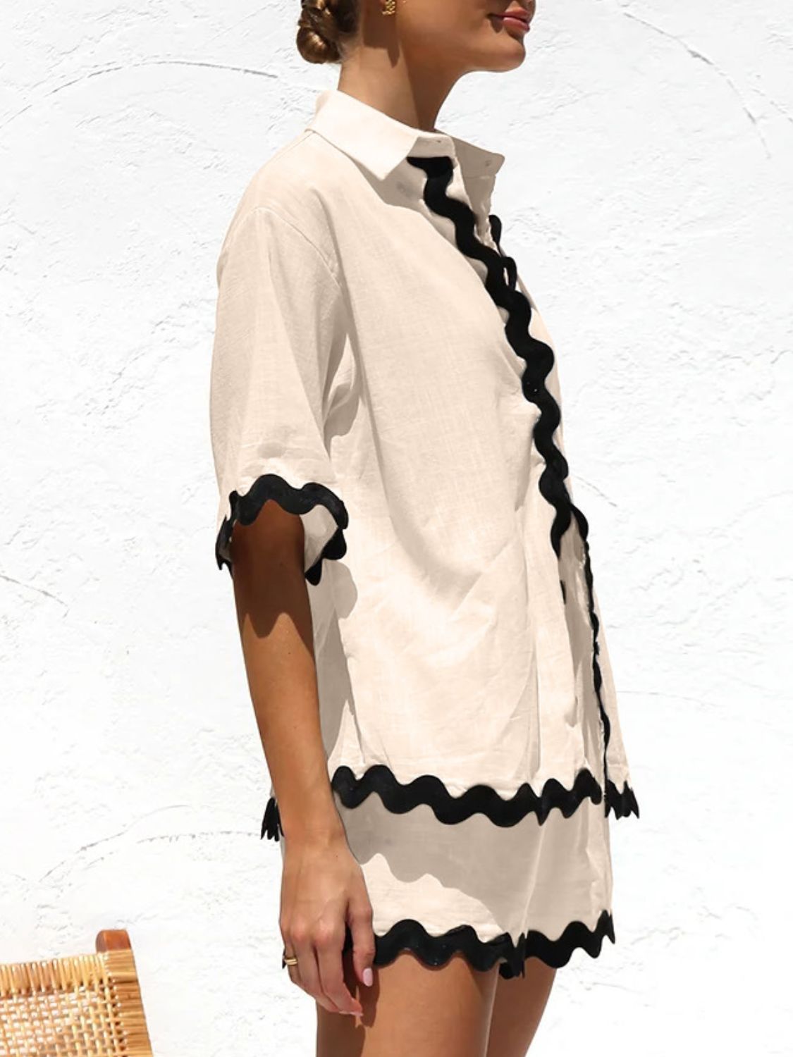 Tan pajama set with black scalloped trim on short sleeves and hem.