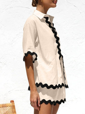 Tan pajama set with black scalloped trim on short sleeves and hem.