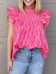 Pink floral print blouse with ruffled flutter sleeves and pintuck detail